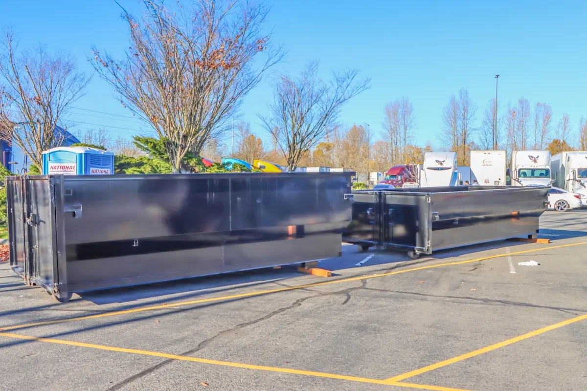 Professional dumpster rental service with roll-off container on residential driveway in Bowleys Quarters